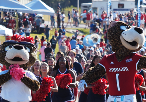 南paw和Ms. Pawla cheering at the Jag Walk before a football game.